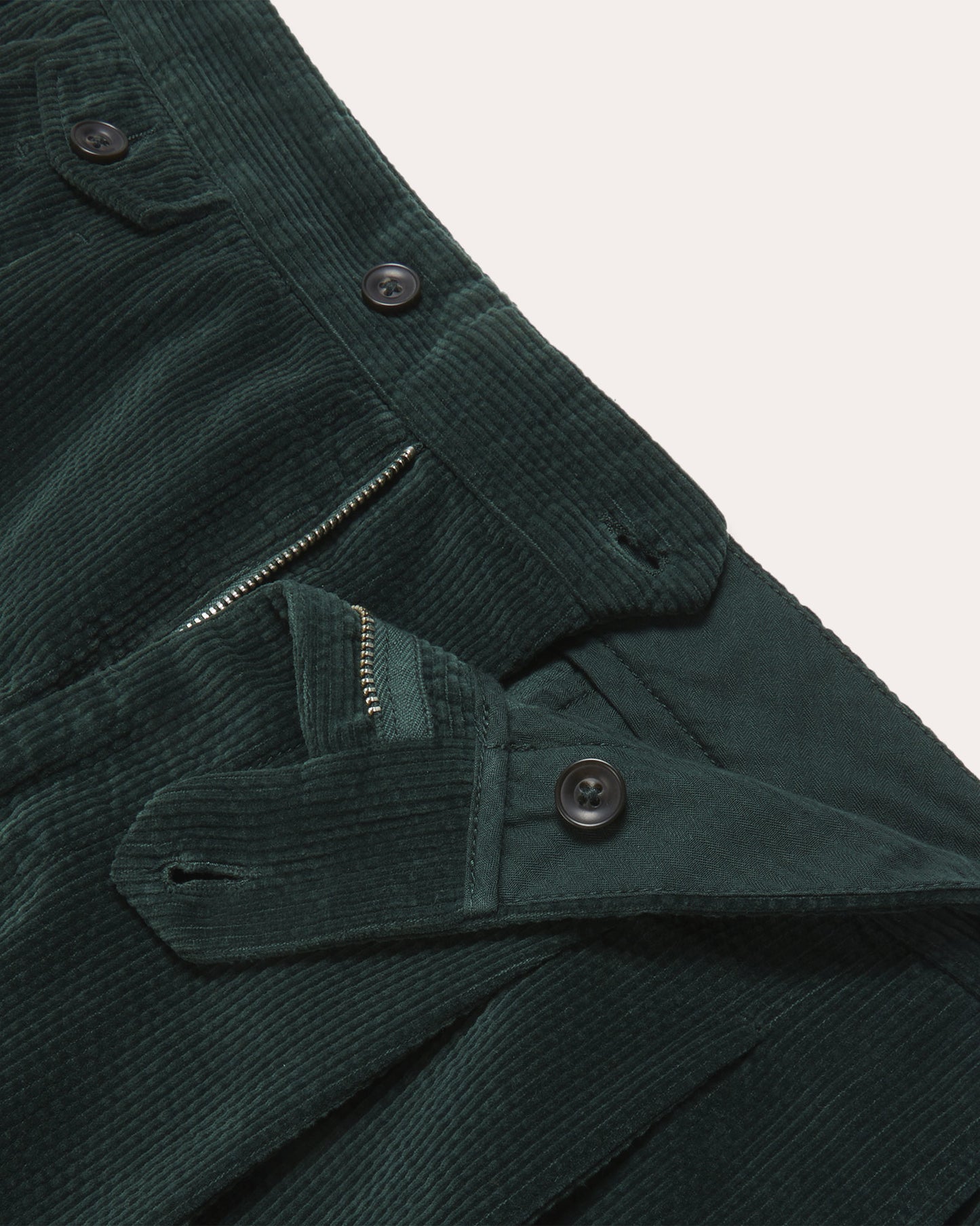 Double-pleated green corduroy trousers