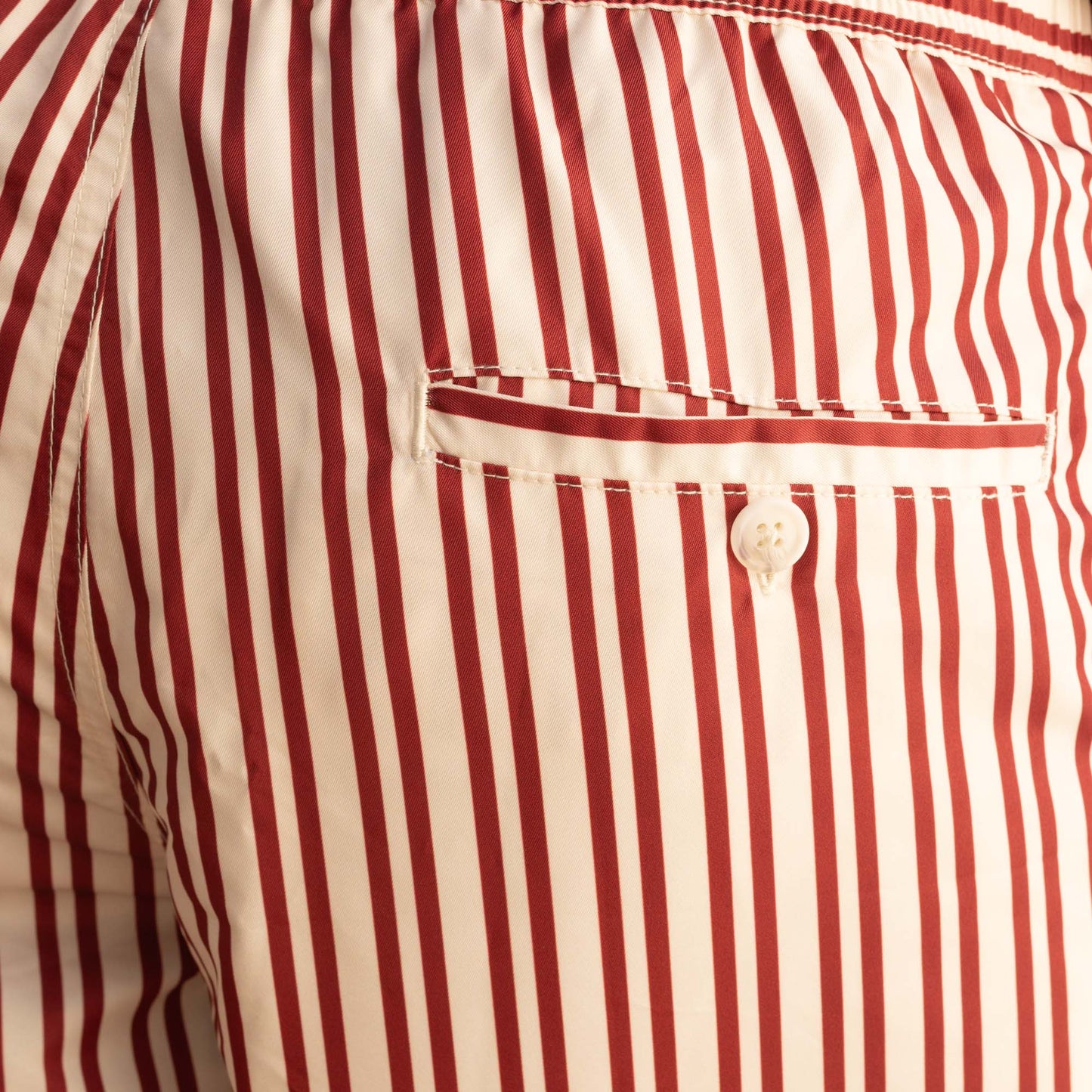 Ecru swimsuit with burgundy stripes in Seaqual®