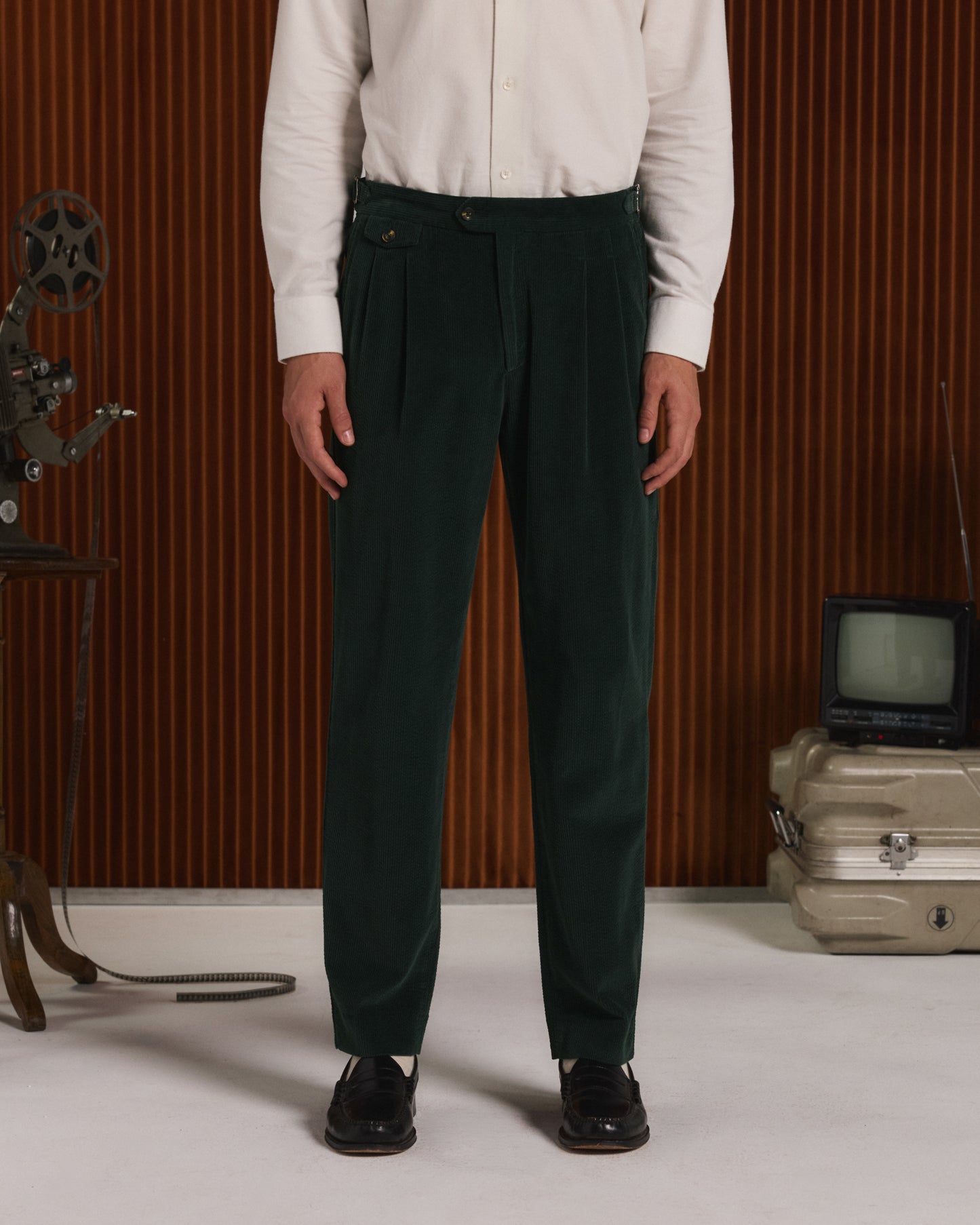 Double-pleated green corduroy trousers