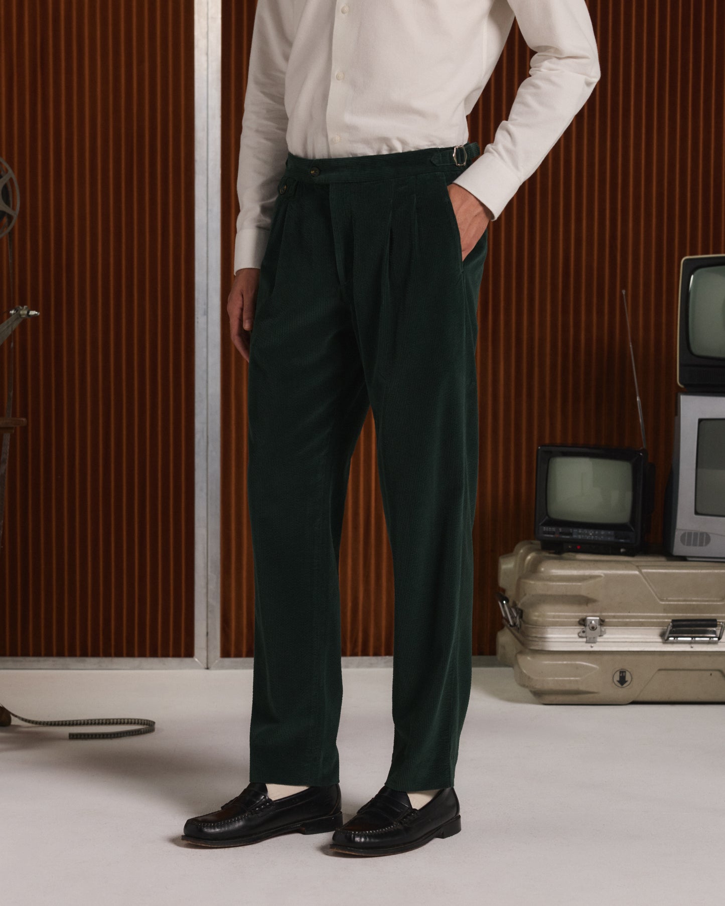 Double-pleated green corduroy trousers