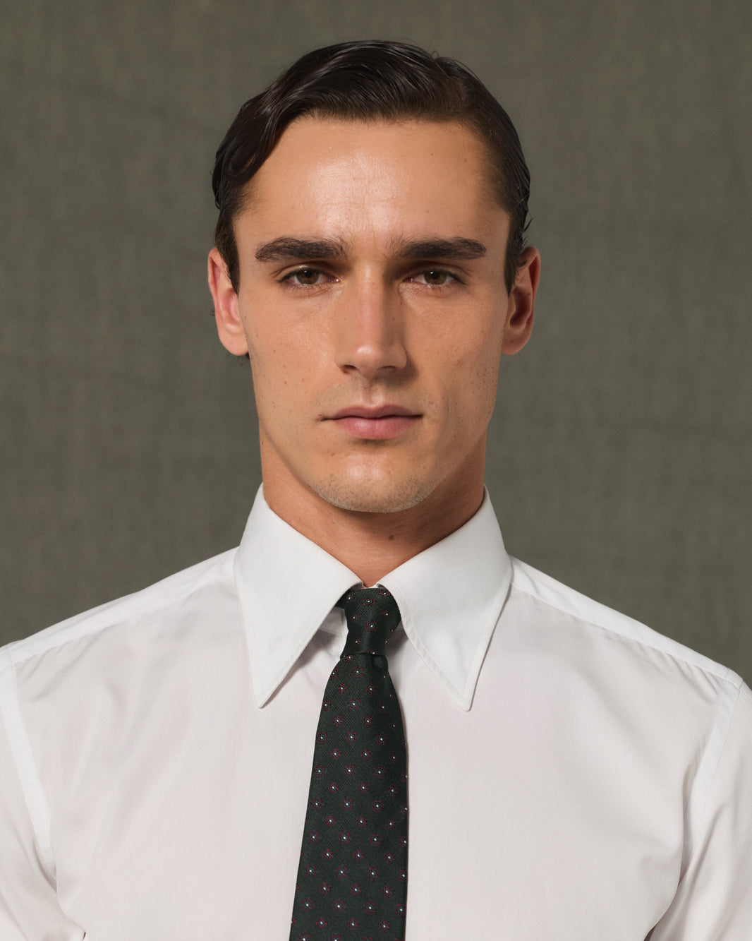 Green silk tie with burgundy patterns